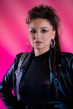 A highly confident individual poses stylishly and expertly in eyecatching fashion against a vibrant pink backdrop