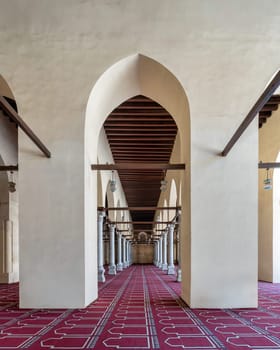 The Al-Zahir Baybars Mosque in Cairo is a testament to Egypt's profound Islamic heritage, characterized by its towering columns, arched passages, and intricately decorated prayer carpet