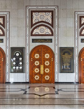 The entrance of Jame' Asr Hassanil Bolkiah Mosque , in Bandar Seri Begawan, Brunei Darussalam, features ornate wooden doors and stunning geometric patterns