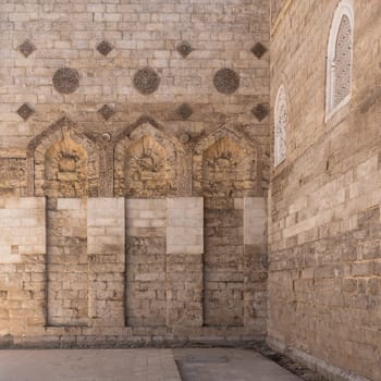 The Mosque of al-Zahir Baybars stands majestic in Cairo, Egypt, showcasing intricate stonework and architectural details under soft golden hour light