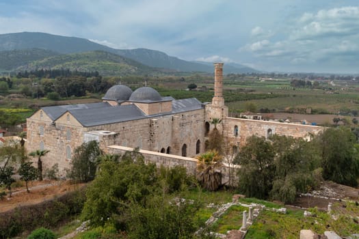 The architectural beauty of Selcuk Isa Bey Mosque in Selcuk, Izmir, turkey. Surrounding landscapes provide a serene backdrop, enriching the historical significance of the site