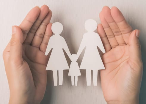 Family with two mothers and child. LGBT concept. Family of paper cutout figures