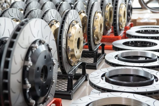 Car mechanic or serviceman disassembly and checking a disc brake and asbestos brake pads for fix and repair problem at car garage or repair shop