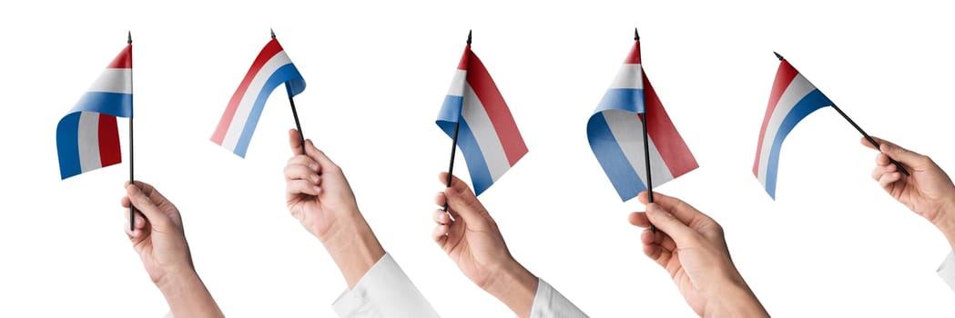 The Netherlands flag in hand in different angles on a white background.