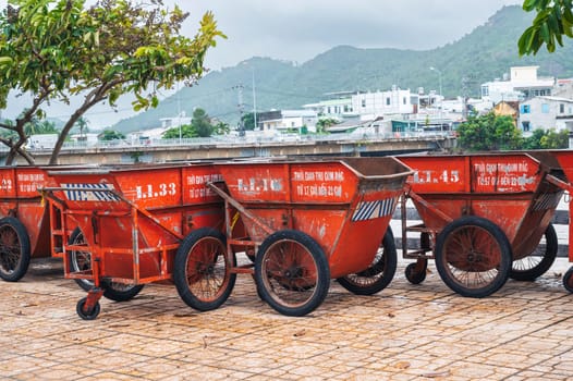 Open empty metal garbage containers. A row of empty trash cans on the beach. Nha Trang, Vietnam - December 13, 2024.