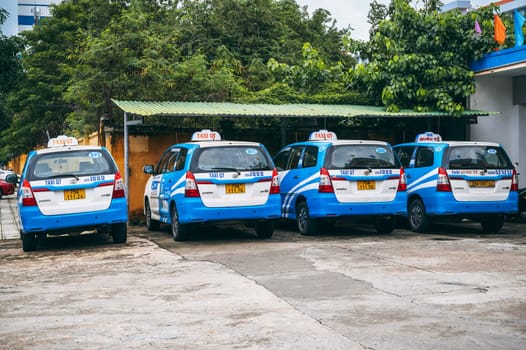 Asian taxi cars are parked in the parking lot. Nha Trang, Vietnam - December 16, 2024