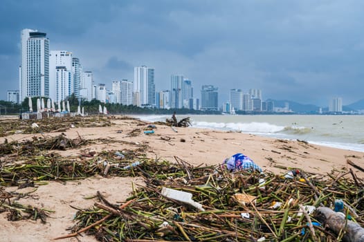 View of the Nha Trang coastline polluted by debris after a storm. Nha Trang, Vietnam - December 16, 2024