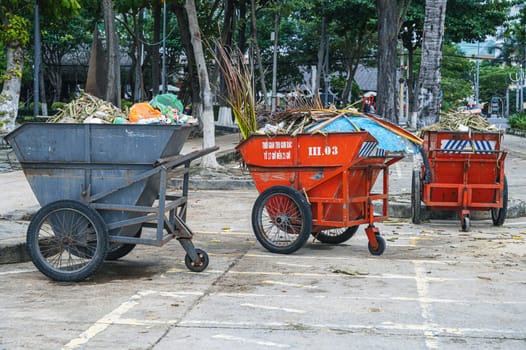 Metal containers full of garbage are standing on a beach in Asia. Nha Trang, Vietnam - December 14, 2024.