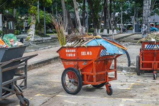 Metal containers full of garbage are standing on a beach in Asia. Nha Trang, Vietnam - December 14, 2024.