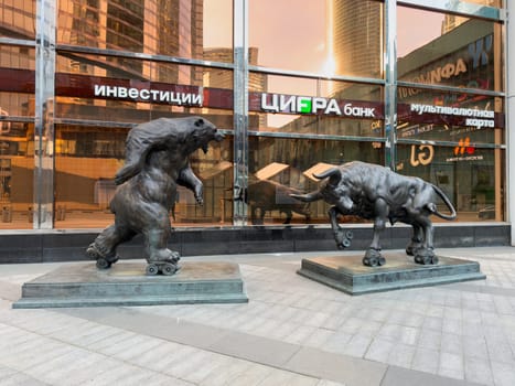 Moscow, Russia, April 26, 2025: Sculptures of bull and bear on roller skates symbolize financial market trends near CIFRA Bank in Moscow City, representing bullish and bearish investment strategies