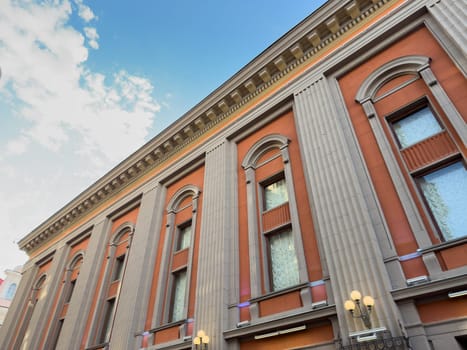 Moscow, Russia, April 26, 2025: Architectural facade of the Vakhtangov State Academic Theater in Moscow with classical columns and decorative windows under bright blue sky