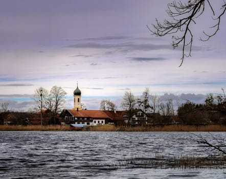 Church at a lake in Bavaria called Froschhauser See on a windy day