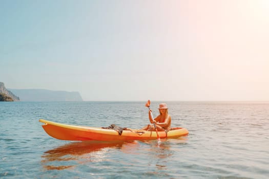 Kayak sea woman. Happy attractive woman with long hair in red swimsuit, swimming on kayak. Summer holiday vacation and travel concept