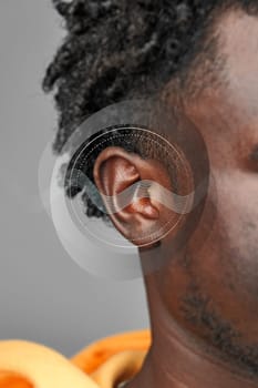 This striking composition showcases a close-up of an ear with sound wave graphics, emphasizing the relationship between human senses and sound. It reflects auditory culture and perception.