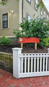 Boston, MA USA - 08.04.2024: Campus Education and Computer Labs Sign Near a White Picket Fence and Brick Walkway.