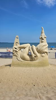 Boston, MA USA - 08.05.2024: Impressive Sand Sculpture of a Reclining Woman on a Sunny Beach, Summer Vacation.