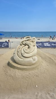 Boston, MA USA - 08.05.2024: Fantasy Sand Sculpture Dragon on Beach, Creative Art, Seaside Scene, Summer Vacation.