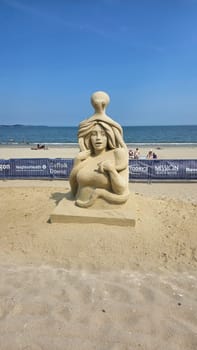 Boston, MA USA - 08.05.2024: Intriguing Sand Sculpture of Woman and Octopus on Beach, Coastal Art and Marine Theme
