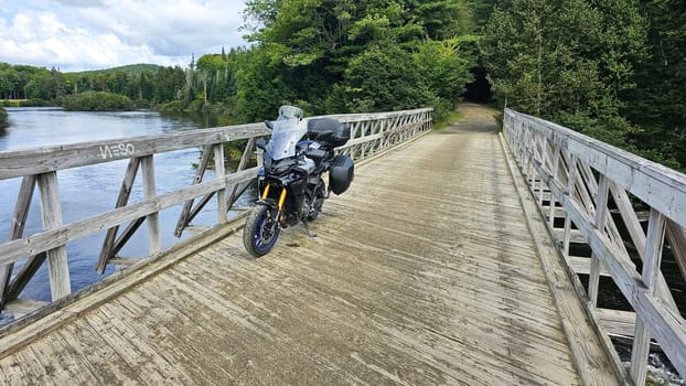 Sargent s Purchase, NH USA - 08.22.2024: Motorcycle Adventure on Wooden Bridge Exploring Scenic Landscapes and Nature Views.