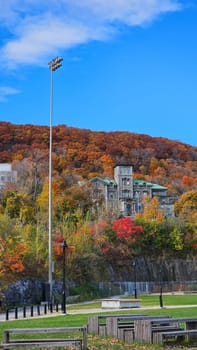 Montreal, QC Canada - 10.27.2024: Autumnal Splendor Scenic Landscape with Historic Building and Vibrant Foliage