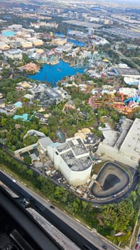 Orlando, FL USA - 12.31.2024: Aerial View of a Large Theme Park with Roller Coasters and Water Features, Orlando, Florida.
