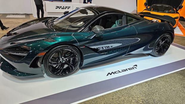 Toronto, ON Canada - 02.16.2025: Elegant Dark Green Sports Coupe Displayed on a White Platform at an Auto Exhibition.