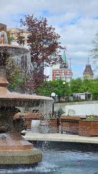 Ottawa, ON Canada - 05.14.2025: Scenic Ottawa Fountain View with Parliament Buildings in the Background on a Sunny Day.