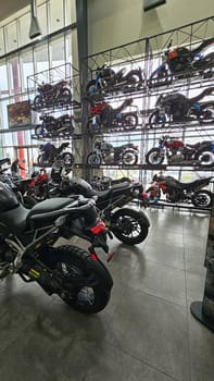 Ottawa, ON Canada - 05.10.2025: Motorcycle Showroom Display Rows of Bikes on Shelves for Sale and Viewing, Interior Shot.
