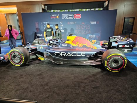 Toronto, ON Canada - 02.23.2024: Sleek Open Wheel Racing Car Displayed at Event with Spectators and Team Members.