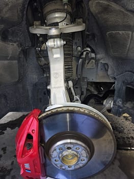 Ottawa, ON Canada - 03.02.2024: Car Suspension System Detailing a Brake Rotor, Caliper, and Strut Assembly on Display.