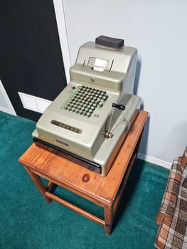 Ottawa, ON Canada - 06.15.2024: Vintage Calculator on Wooden Stand A Nostalgic Addition to Any Collection or Display