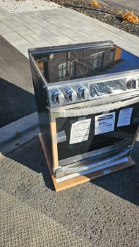 Ottawa, ON Canada - 05.14.2024: New Cooking Range Ready for Installation, Modern Kitchen Appliance on Outdoor Surface.