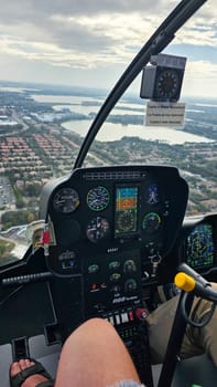 Orlando, FL USA - 12.31.2024: Helicopter Flight Over Urban Landscape. Aerial View of the City From Cockpit, Rotorcraft Flight Deck.
