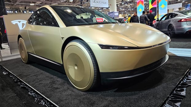 Toronto, ON Canada - 02.16.2025: Sleek Cybercab Tesla Robotaxi Car on Display at Auto Show, Innovative Design and Futuristic Features.