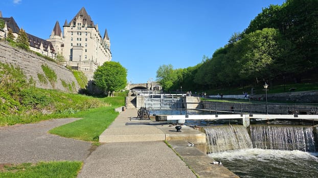 Ottawa, ON Canada - 05.14.2025: Picturesque Canal Locks and Stone Buildings under Clear Blue Sky on a Sunny Day