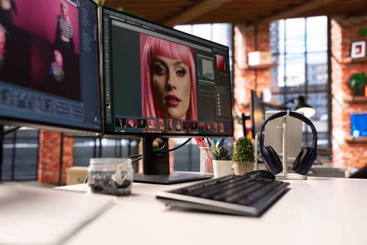 Professional studio setup for AI generated content and photography editing. Empty workspace with monitors displaying retouching software, supports creative careers in visual design.