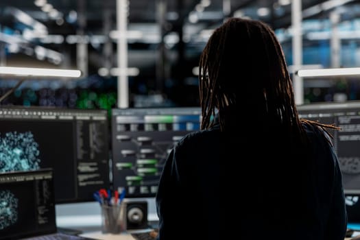 Data center employee using node trees and machine learning algorithms to analyze large datasets. Server room engineer using artificial intelligence to recognize patterns in facility data