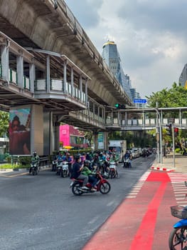 Bangkok, Thailand - November 11, 2024: Usual chill traffic on multiple lane highway with road infrastructure in city center. Metropolitan street with cars driving, urban transport.