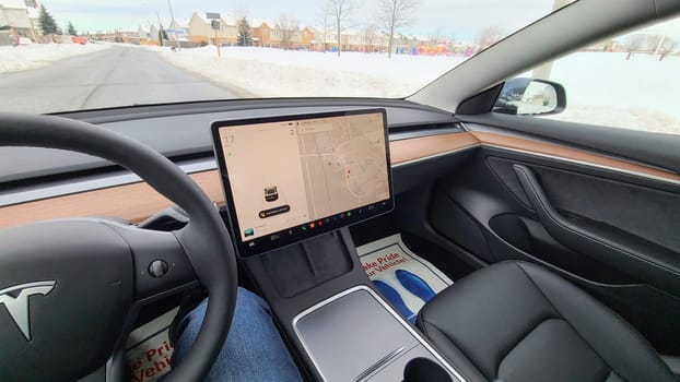 Ottawa, ON Canada - 12.27.2024: Interior View of a Modern Tesla electric Vehicle with Navigation System Displayed on the Screen.