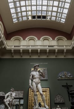 London, UK - May 07, 2025 - London, UK - May 07, 2025 - A magnificent plaster cast of Michelangelo's David sculpture, uses metal rods to support the structure to mount the left and right arms to the torso Displayed in The V&A (Victoria and Albert Museum) in London. use it as your Wallpaper, Poster and Space for text, Selective focus.