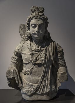 London, UK - May 07, 2025 - Bust of a Bodhisattva Maitreya Sculpture (Sanskrit) or Metteyya (Pali) displayed in The V&A (Victoria and Albert Museum), is a central figure in Mahayana Buddhism and in Tibetan Buddhism he is known as the "Lord of Love" or the "Noble Loving One" (Pakpa Jampa), and his name means "friendliness" or "loving-kindness". use it as your Wallpaper, Poster and Space for text, Selective focus.