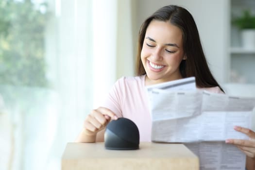 Happy woman learning to use a smart speaker reading manual