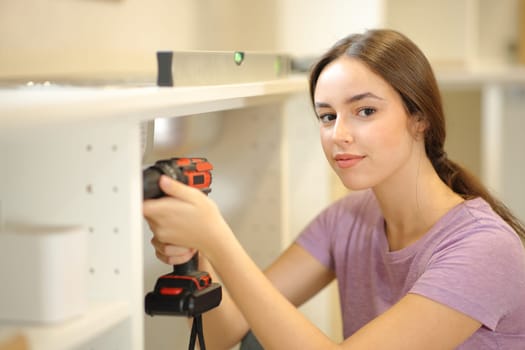 Portrait of a woman reforming house looking at camera in the kitchen