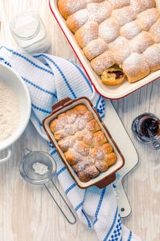Sweet rolls, Buchteln (buchty) filled with plum jam or jelly with backing ingredients. Typical Czech sweet buns made of yeast dough