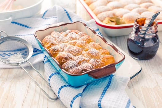 Sweet rolls, Buchteln (buchty) filled with plum jam or jelly with backing ingredients. Typical Czech sweet buns made of yeast dough