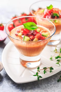 Tomato gazpacho soup with fresh cucumbers. Traditional spanish cold tomato soup of fresh raw vegetables