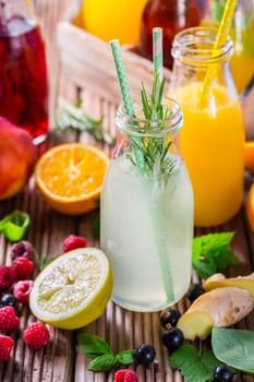 Prepaing refreshing summer drinks and lemonade with fruits and berries