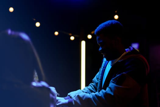 Two individuals interact in a dimly lit setting adorned with string lights. Their expressions reflect warmth and connection during a lively evening gathering.