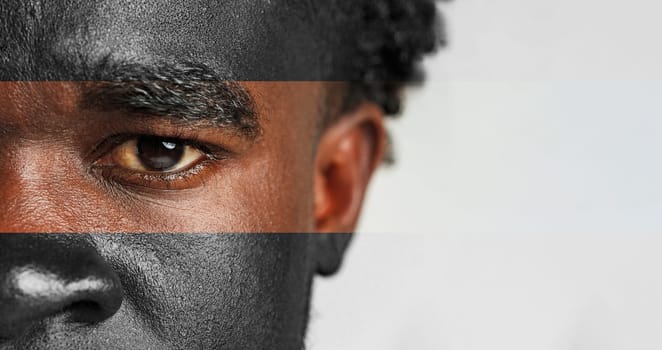 This close-up focuses on the face of a man showcasing beautiful skin texture and a creative makeup design. His intense gaze captures attention against a neutral background.