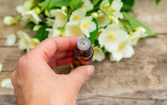 Jasmine essential oil and flowers. Selective focus. nature.